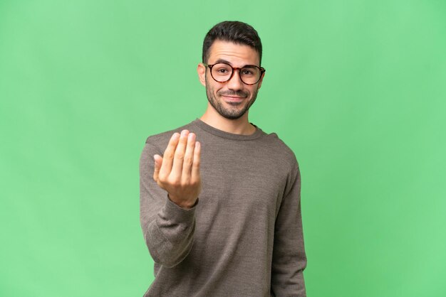 young-handsome-caucasian-man-over-isolated-background-inviting-to-come-with-hand-happy-that-you-came_1368-449237